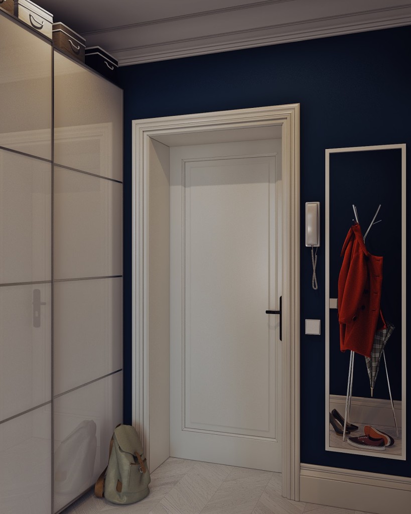 porta d'ingresso bianca con parete blu oltremare, armadi a muro con ante scorrevoli e specchio sulla destra