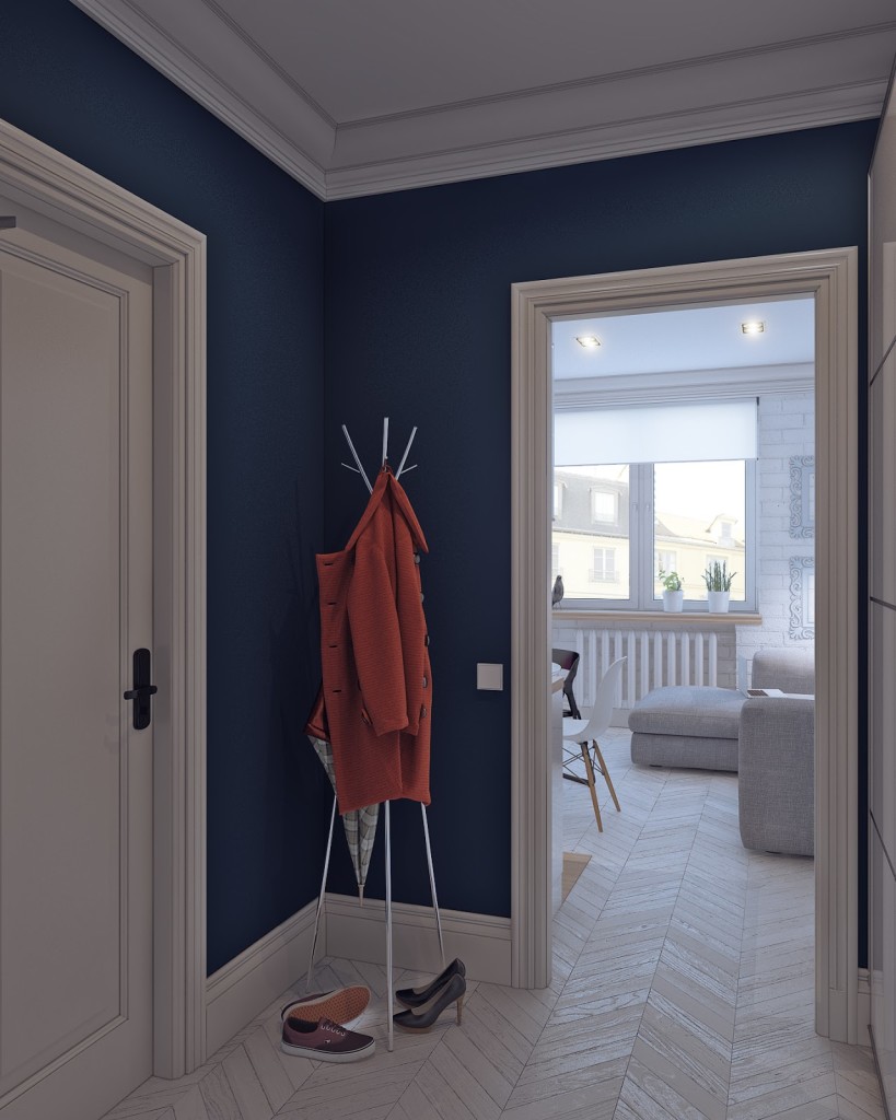 ingresso con pareti blu oltremare, porte con stipiti con decoro classico e appendiabiti da terra. Parquet a spina ungherese