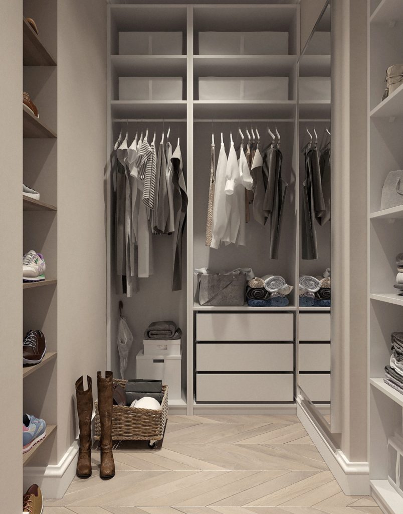 cabina armadio bianca con vestiti chiari appesi e stivali sul pavimento